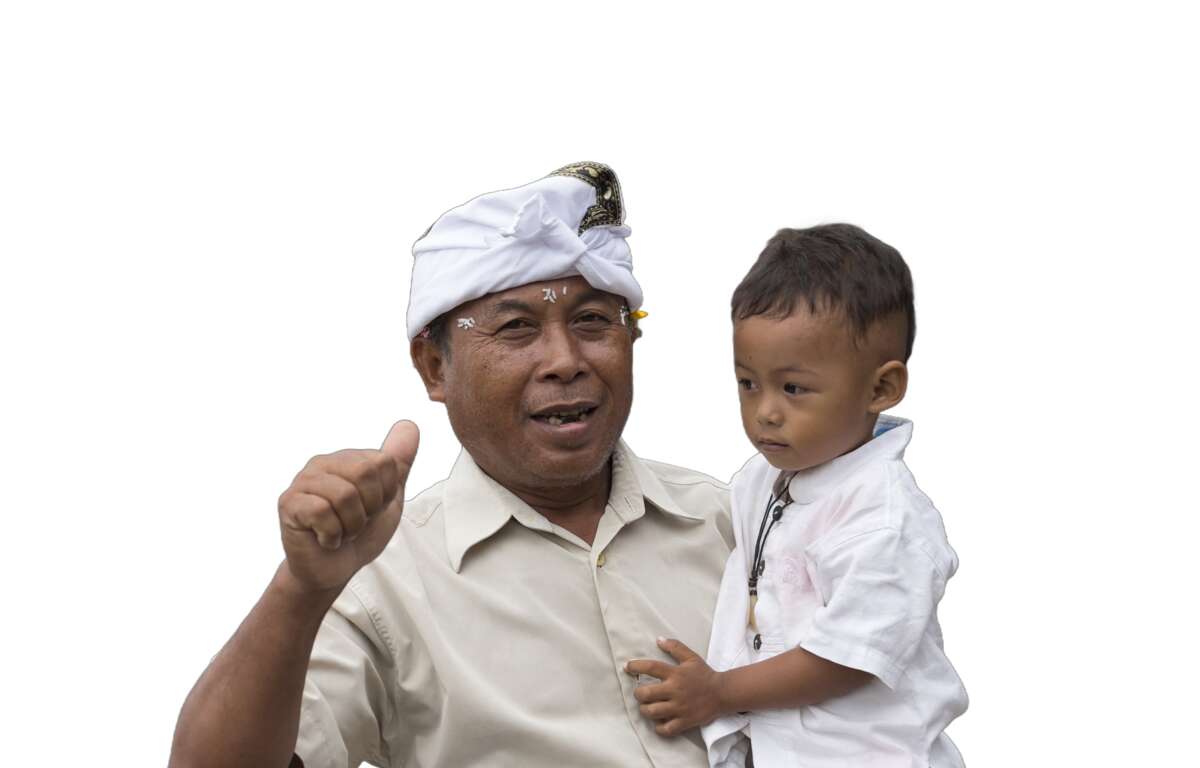 Un hombre de la tercera edad cargando a un niño. Foto de Uwe Aranas.